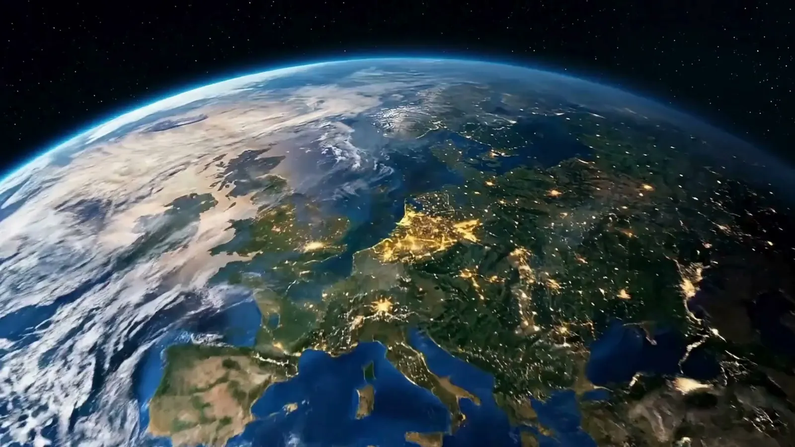 Europe at night from orbit, city lights across the continent, the curve of the Earth against black space.