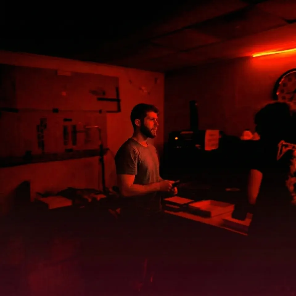TaleCrafters creative director working in a red-lit studio, human taste meeting machine velocity